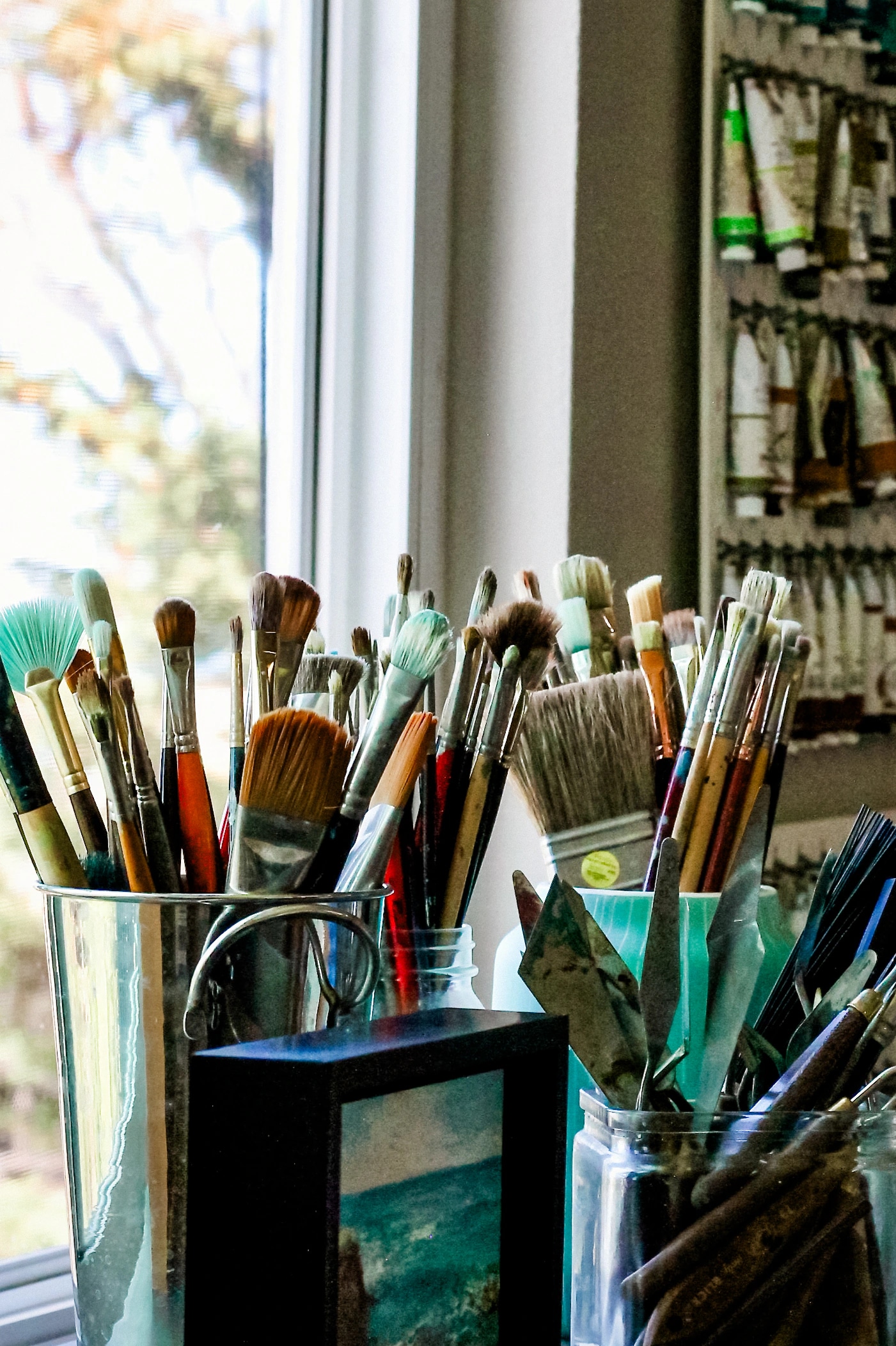 Jill Weeks Smith’s paint brushes and studio tools beside a window
