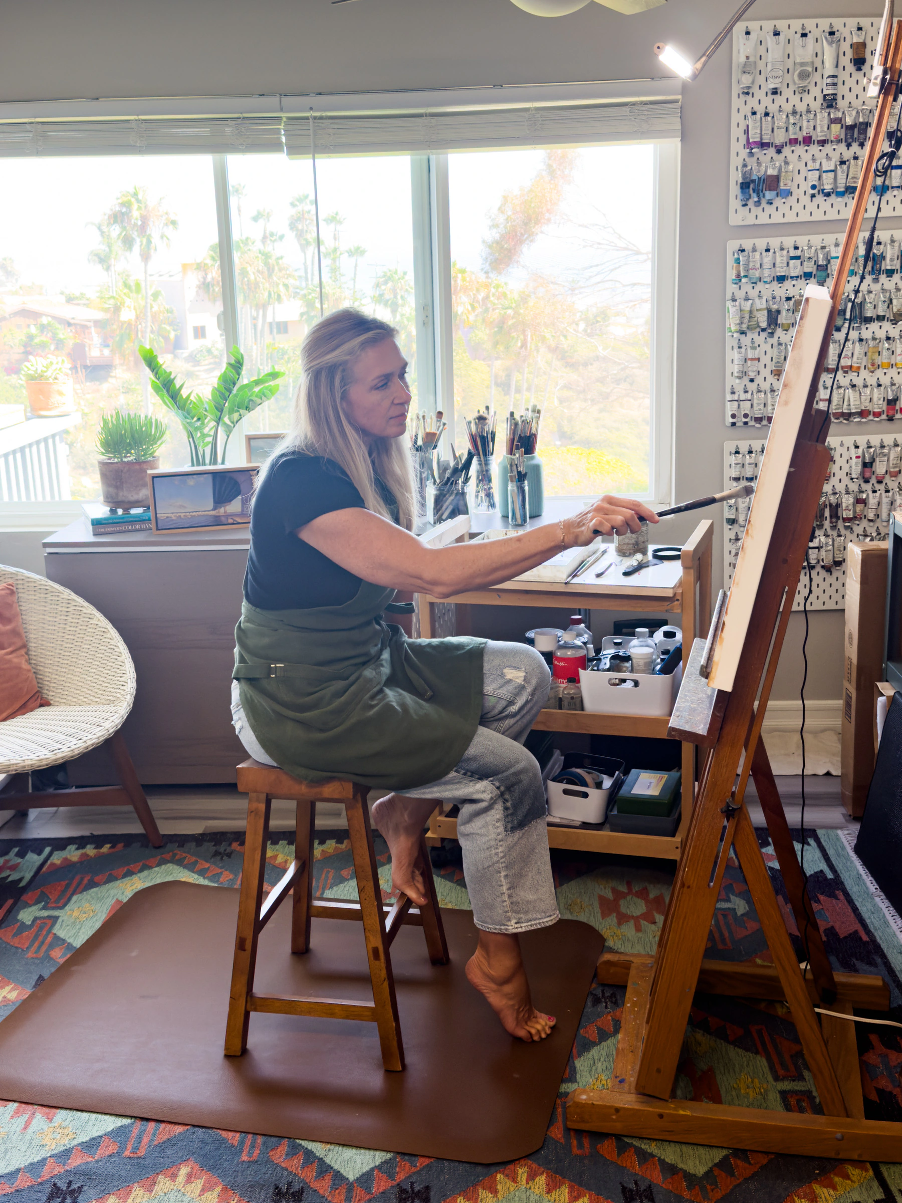 Jill Weeks Smith painting in her light-filled San Diego studio